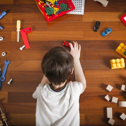 Child playing with toys on luxury vinyl flooring | Neils Floor Covering